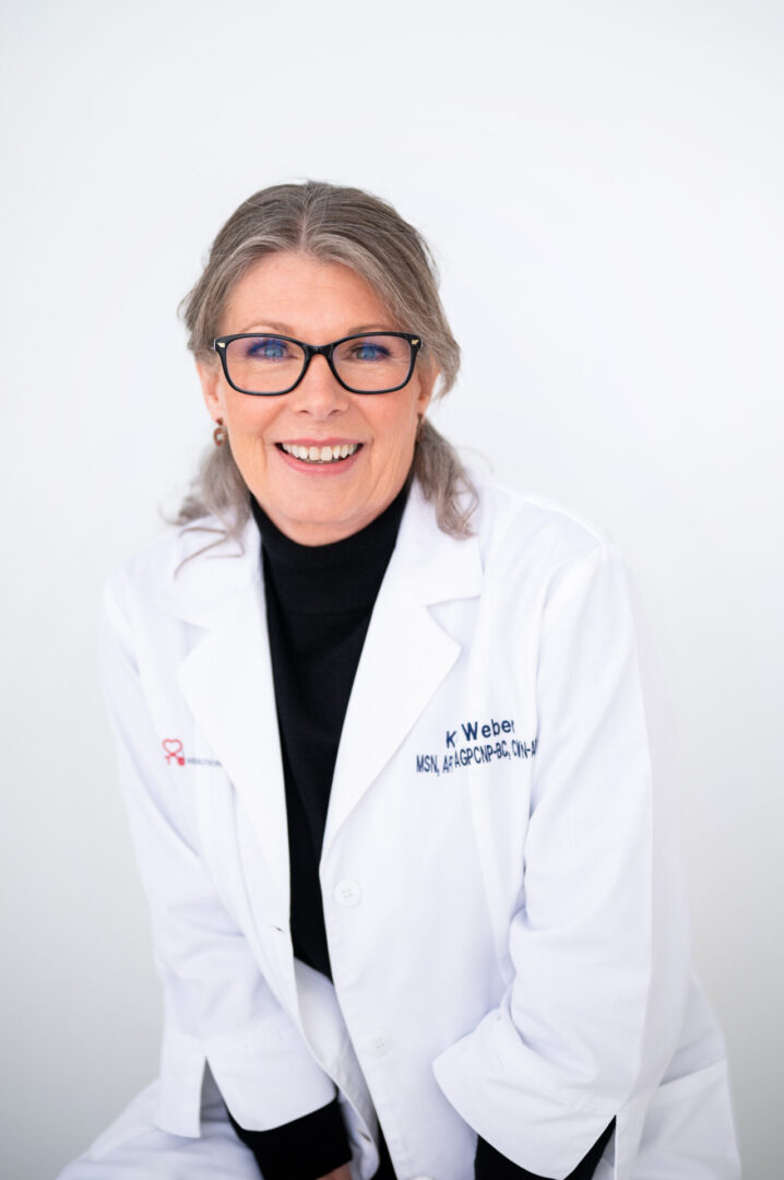 A woman in white lab coat and glasses.