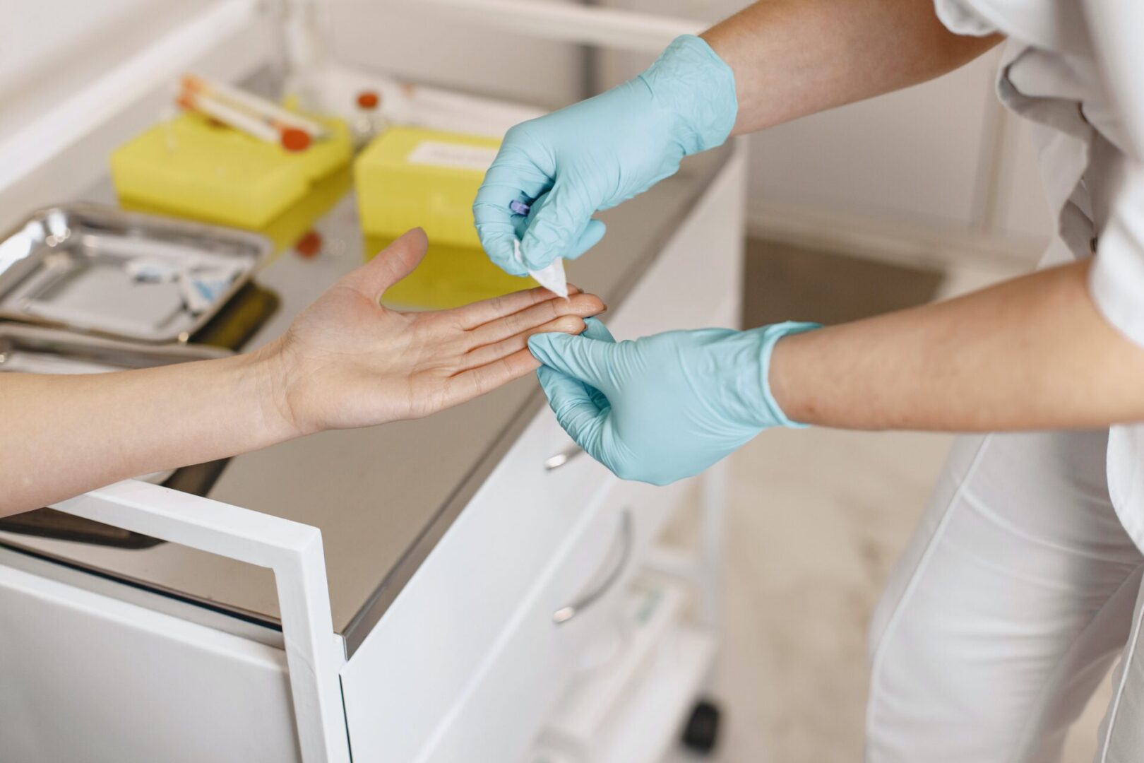 A person is getting their nails trimmed by someone.